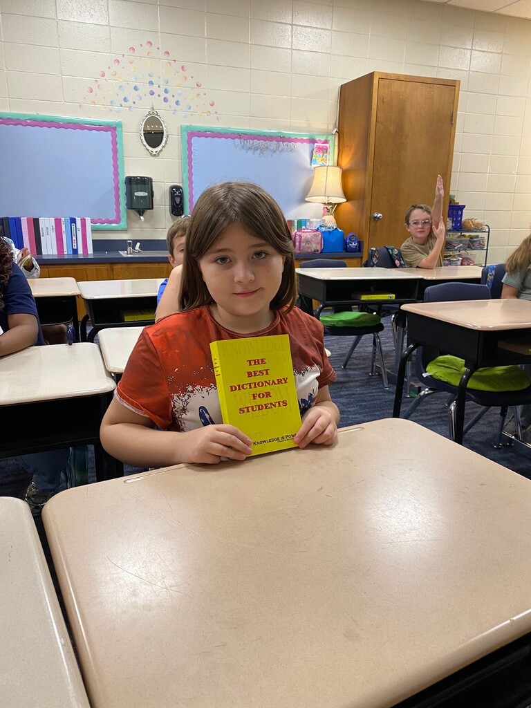 Student smiling with Dictionary