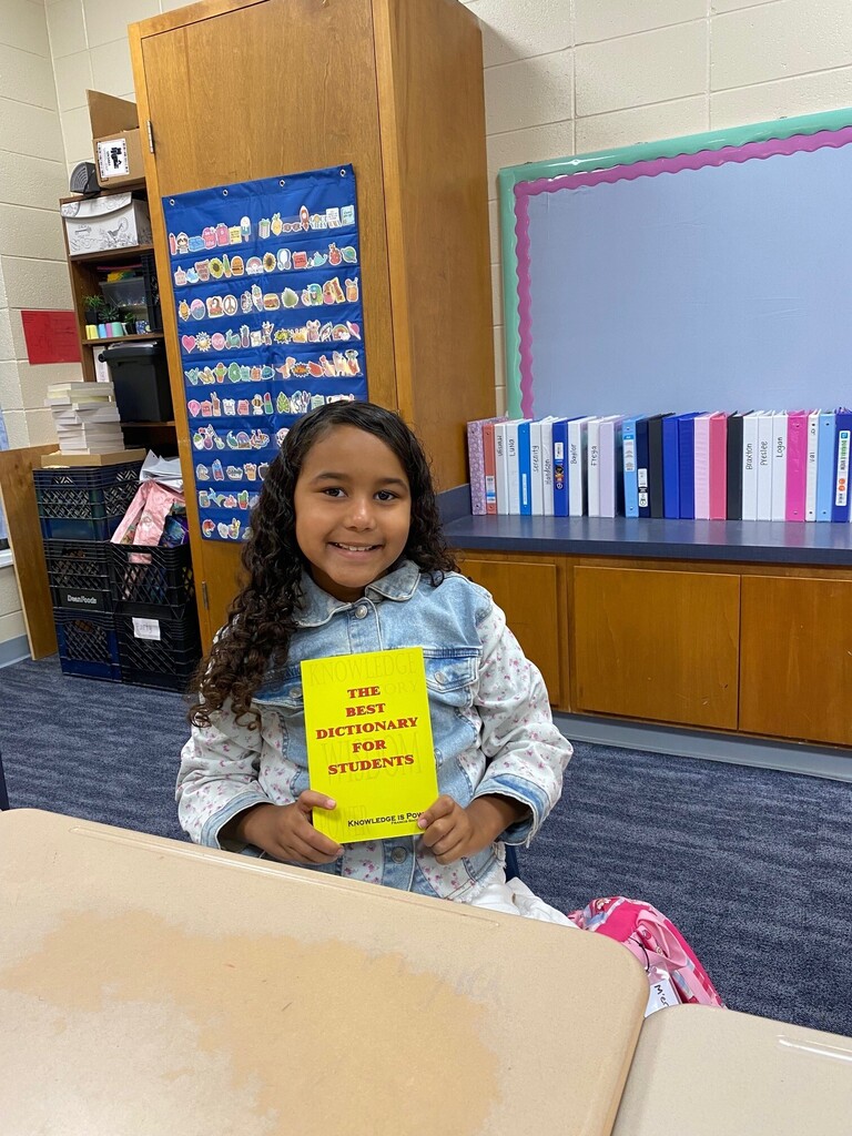 Student smiling with Dictionary