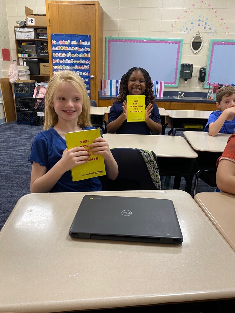 Student smiling with Dictionary