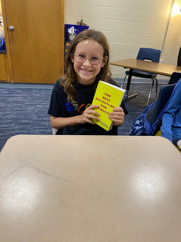 Student smiling with Dictionary