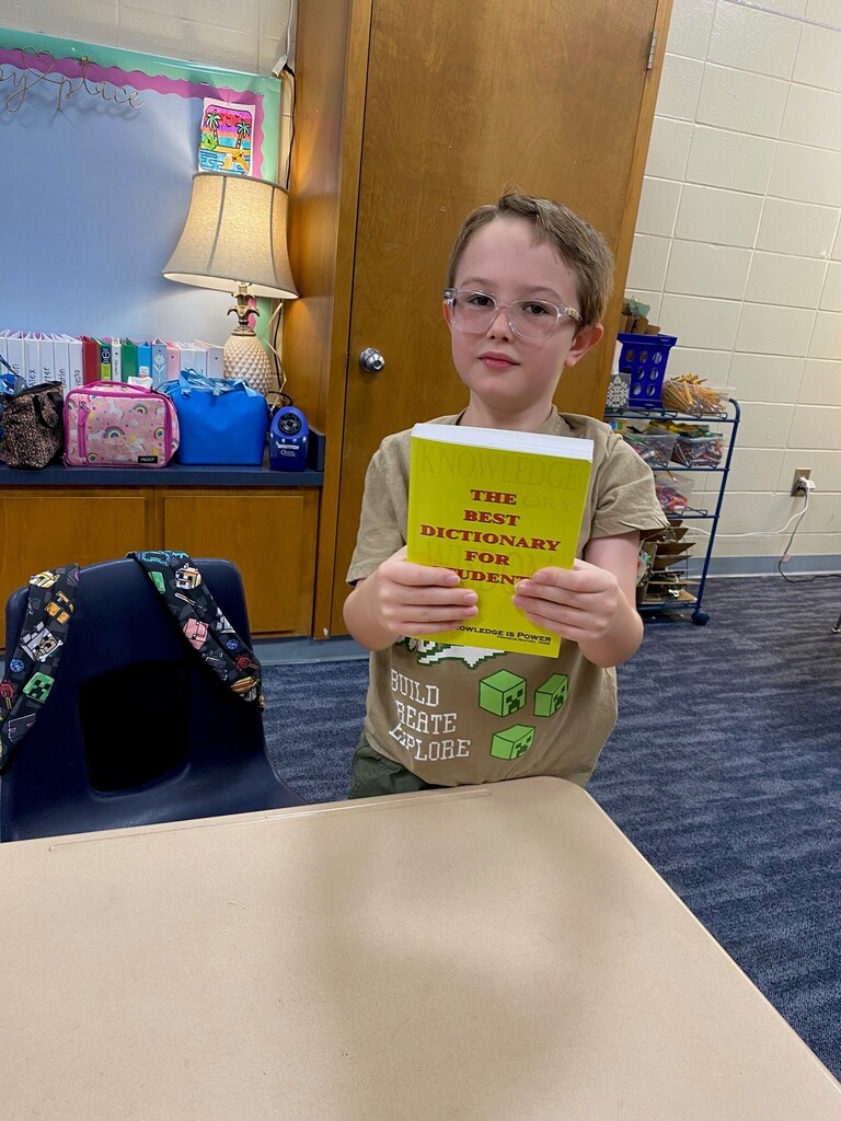 Student smiling with Dictionary