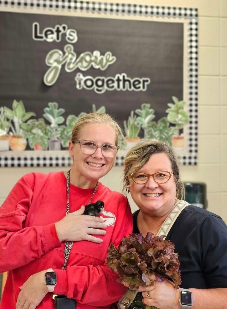 Mrs. Shaske and Mrs. Millan showing off ag produce