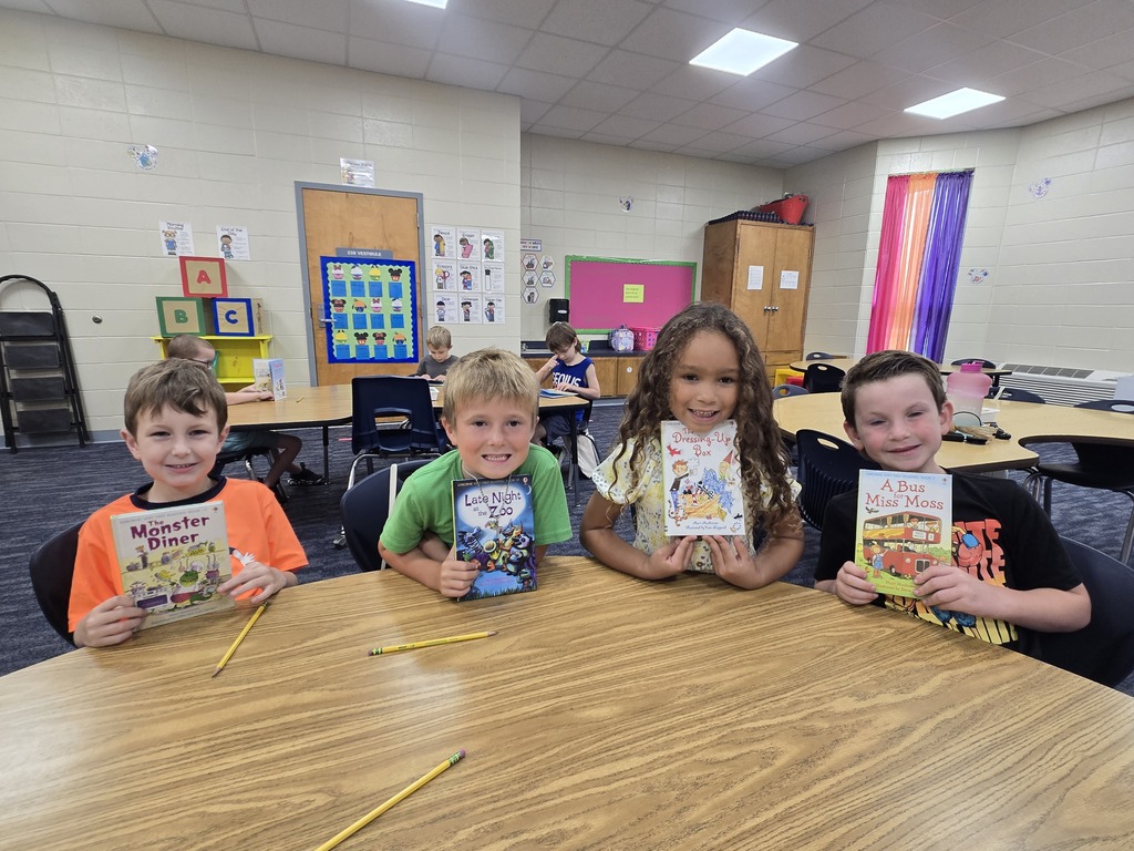 First graders holding up their new book!