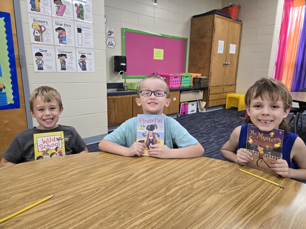 First graders holding up their new book!
