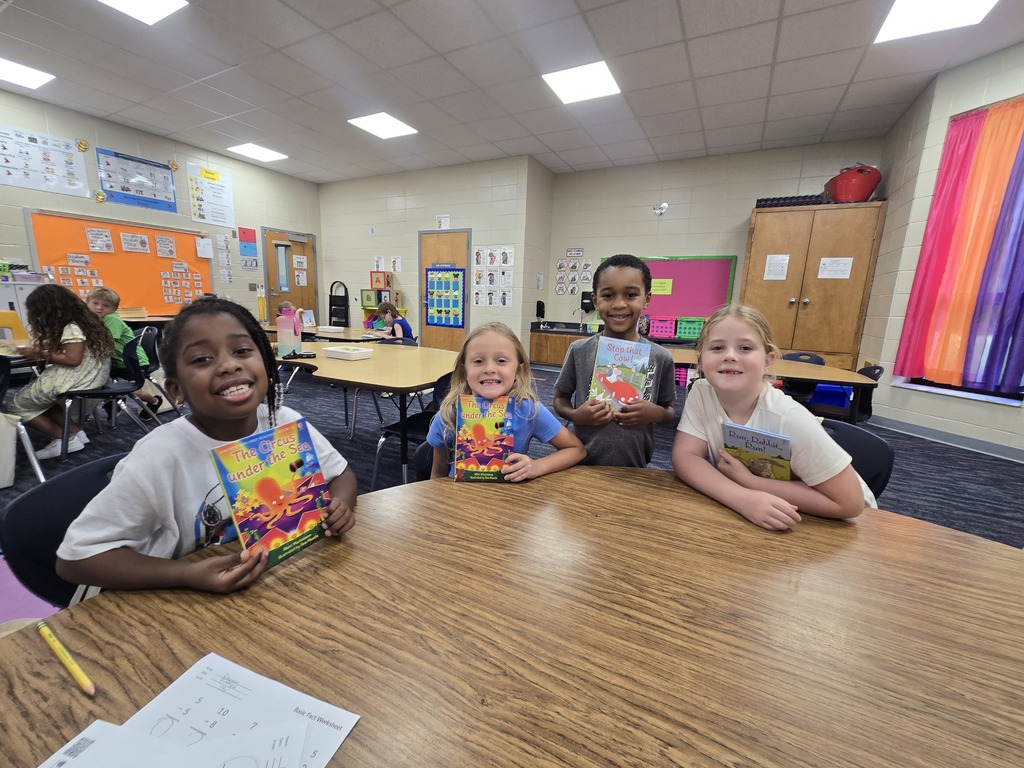 First graders holding up their new book!