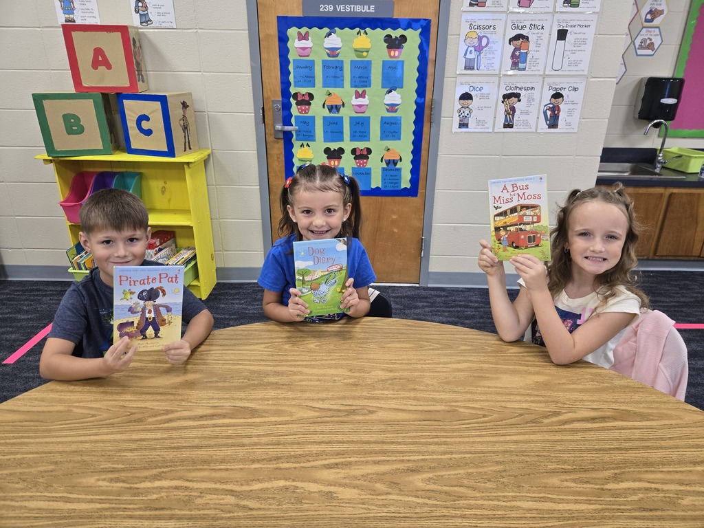 First graders holding up their new book!