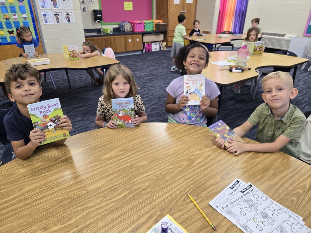 First graders holding up their new book!