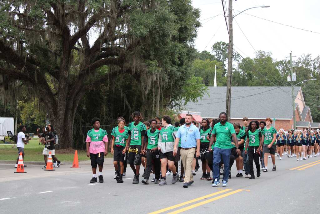 Football team marching in the homecoming parade