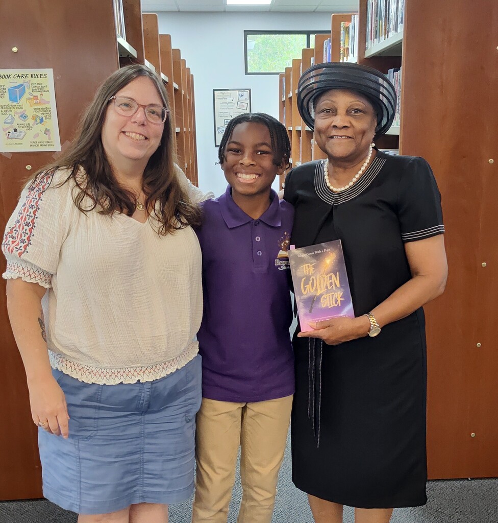 Mrs. George and Mrs. Massey with student and published author Jamal Brown