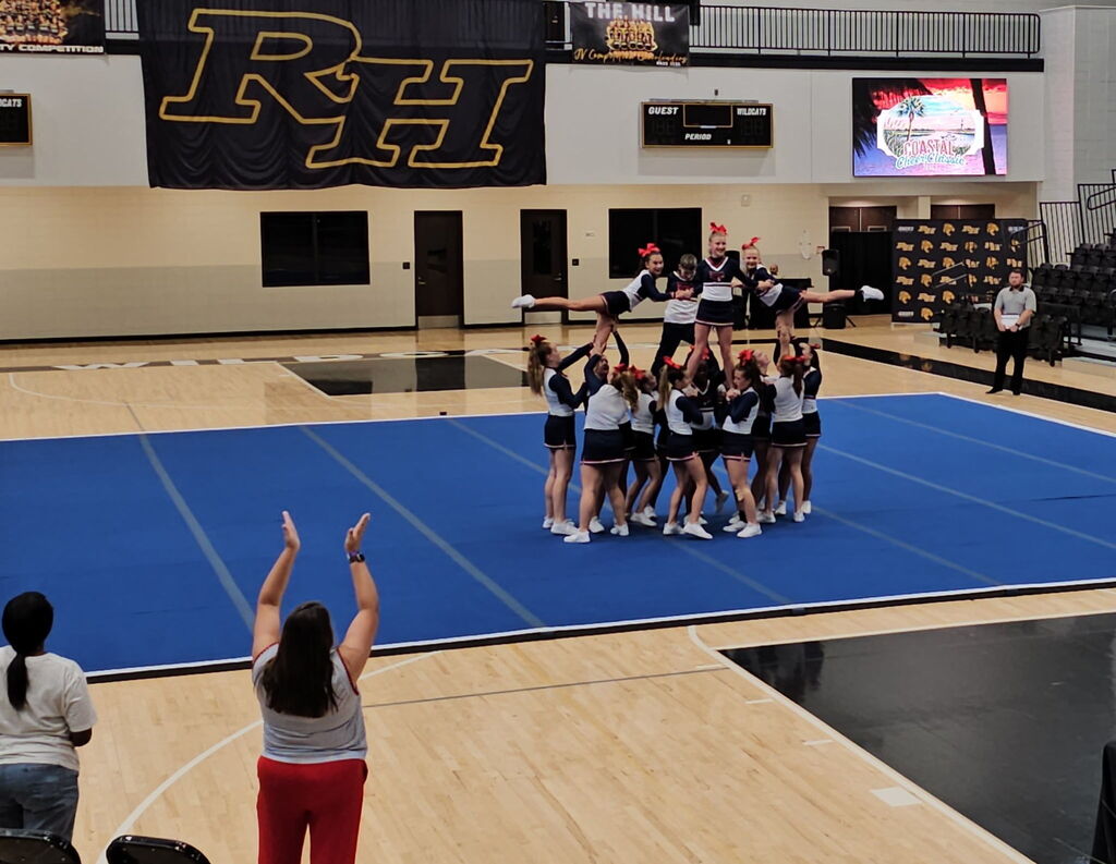 Cheerleaders forming a pyramid.