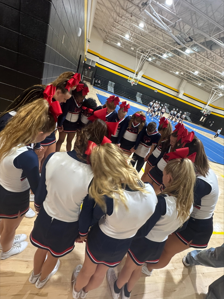 Cheer picture of girls in a huddle before they compete.