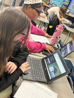 Bessette's Bird Club photo of girl working on her laptop.
