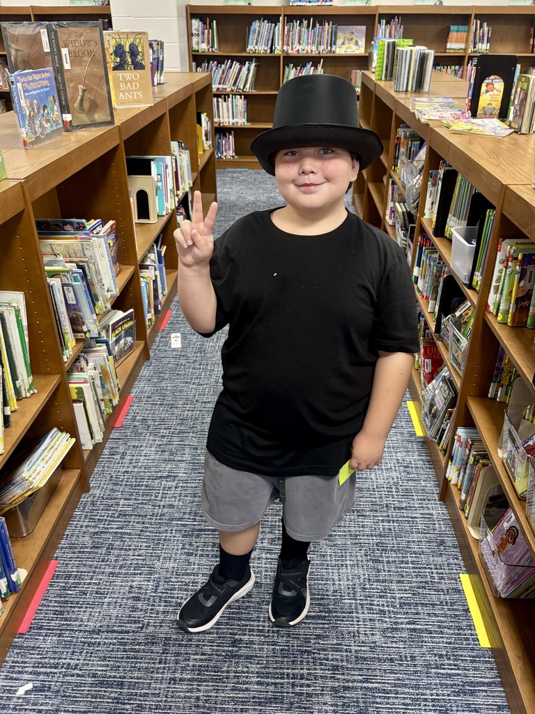 Boy wearing a black top hat.