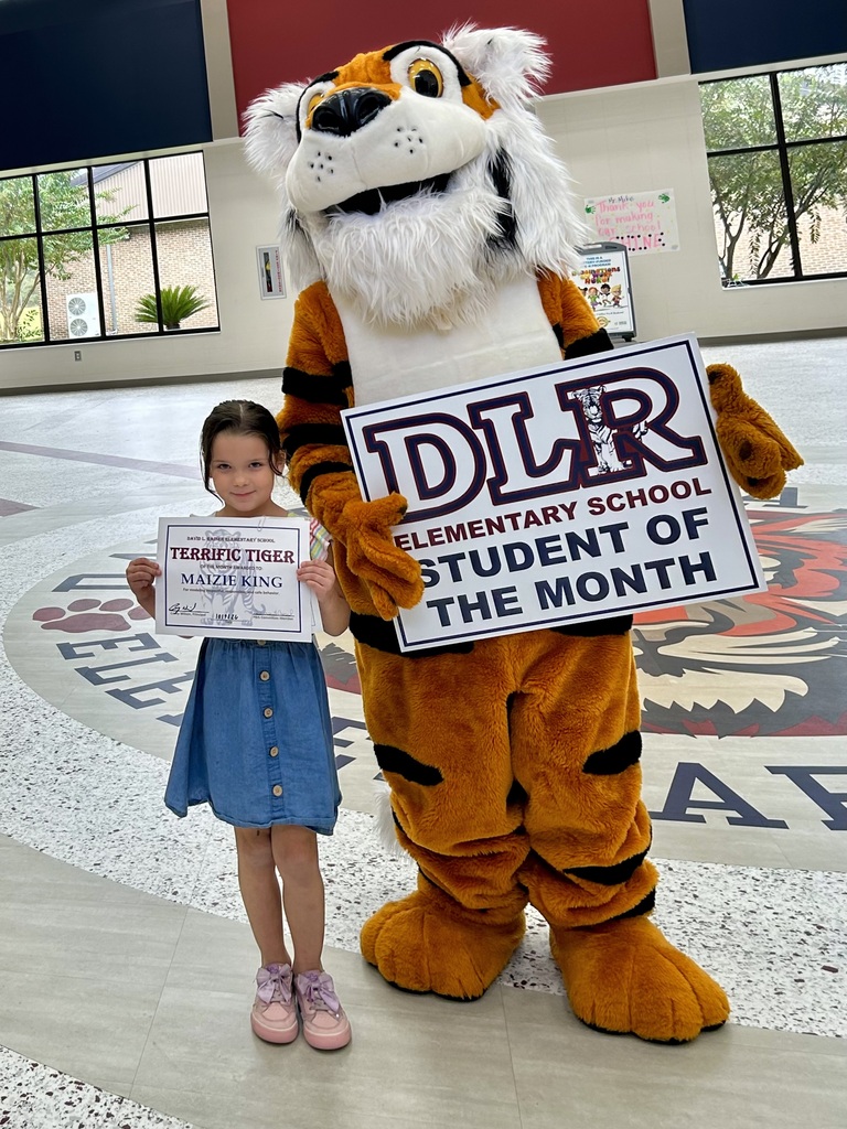 Girl standing with Tiger mascot holding a sign that says "DLR Elementary School Student of the Month"