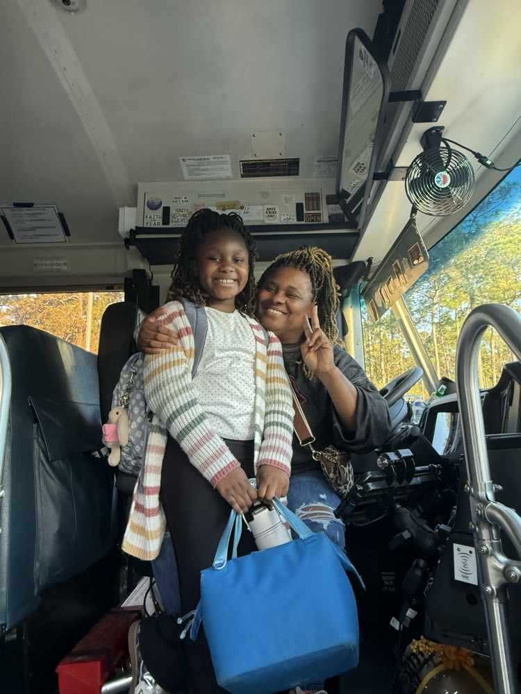 bus driver and student smiling