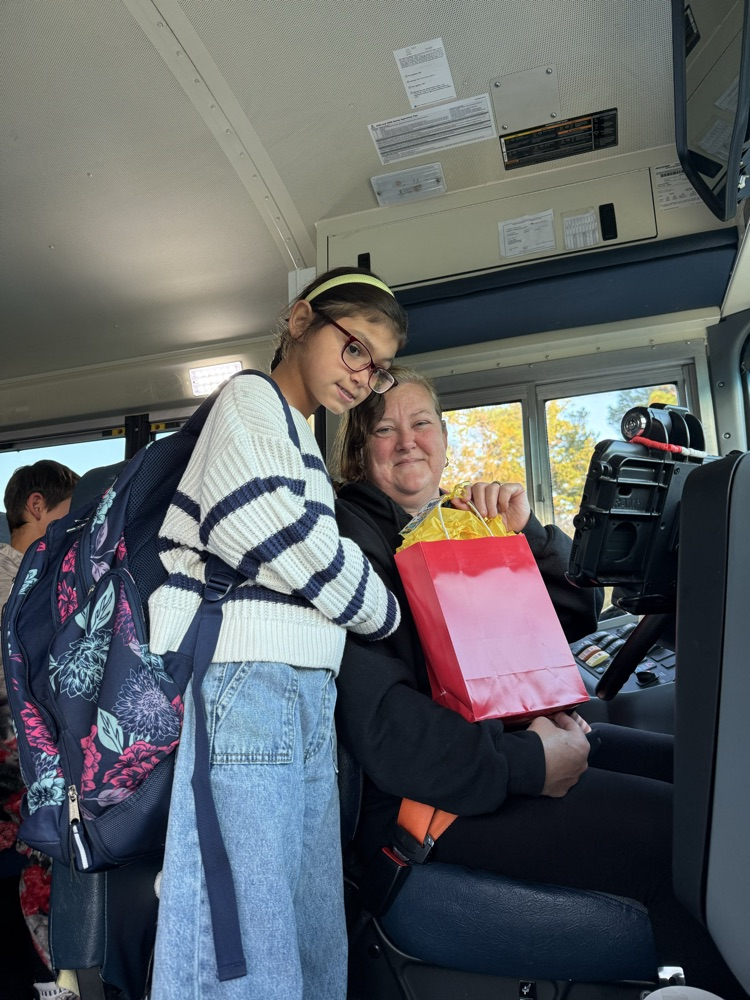 bus driver and student smiling