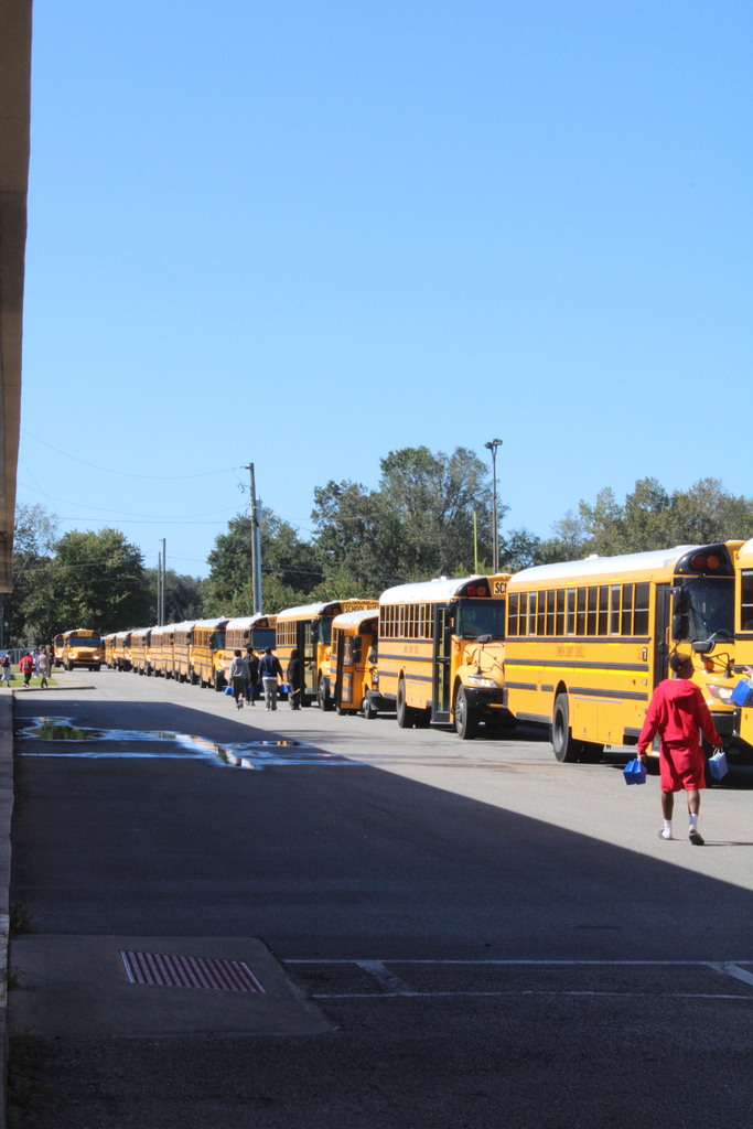 Students delivering bags to bus drivers