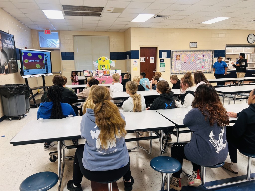 Students watching presentation from entreprenuer.