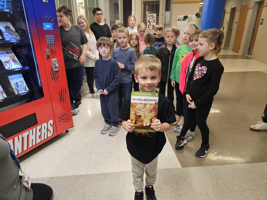 Student holding book for camera