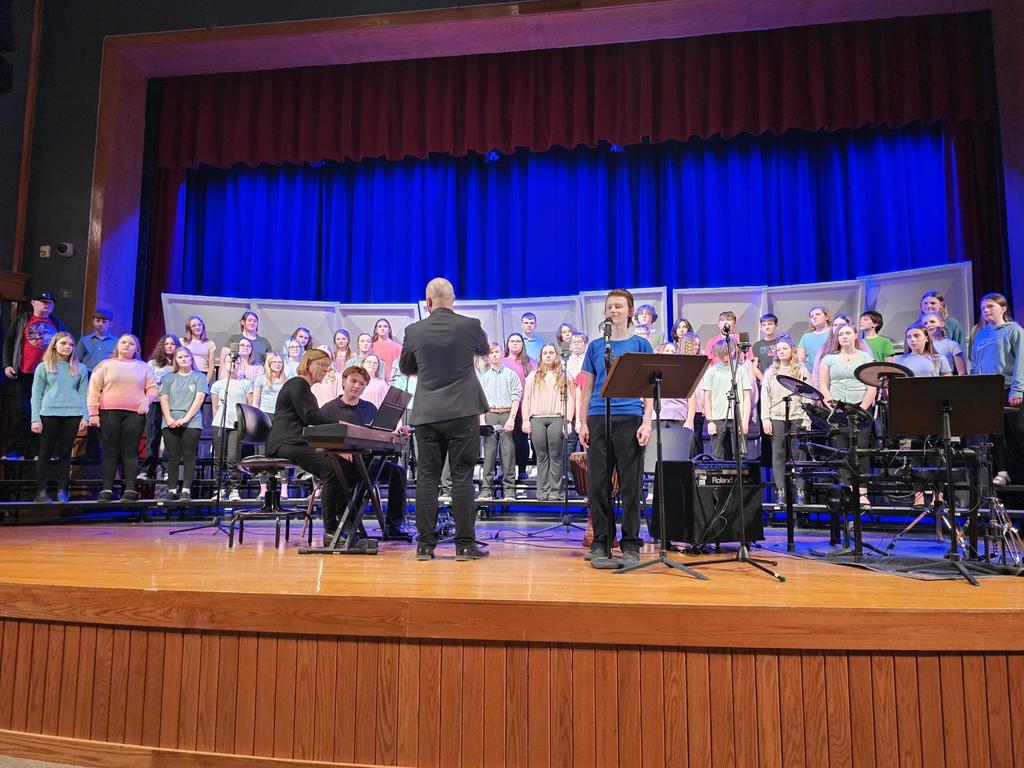 Students on stage performing in chorus