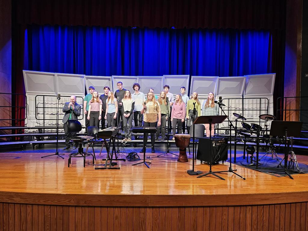 Students on stage performing in chorus