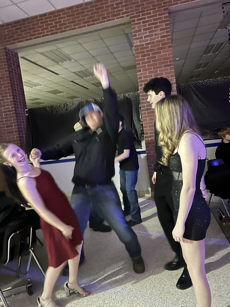 Students dancing at dance and smiling