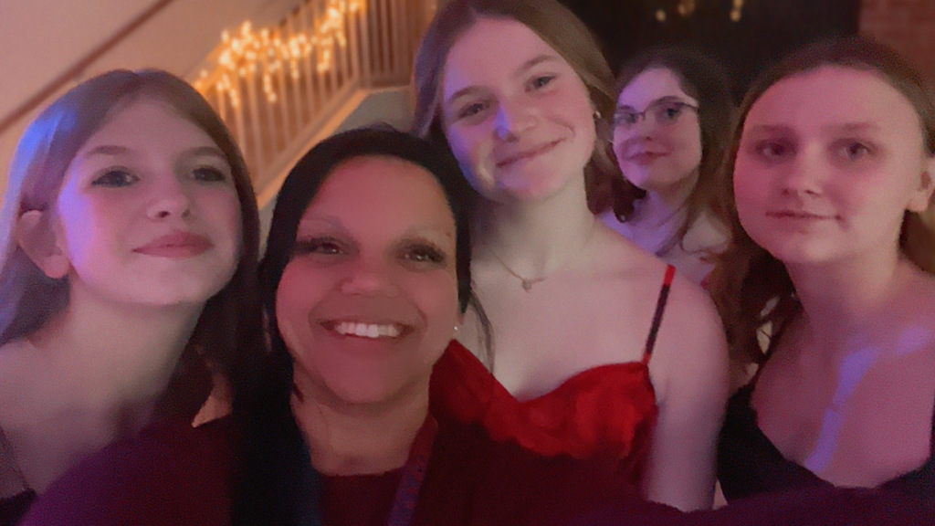 Students posing in picture with adult at dance