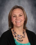 Yearbook pic of teacher with black sweater wearing a necklace