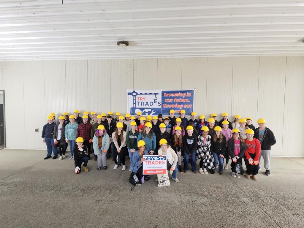 Group picture of 9th graders in yellow hard hats
