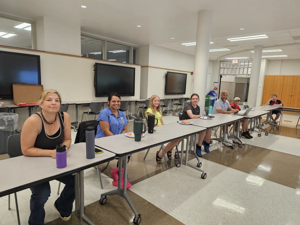 Student council members sitting at table with new principal