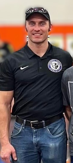 Josh Simmons in a black shirt with Campbell emblem and hat