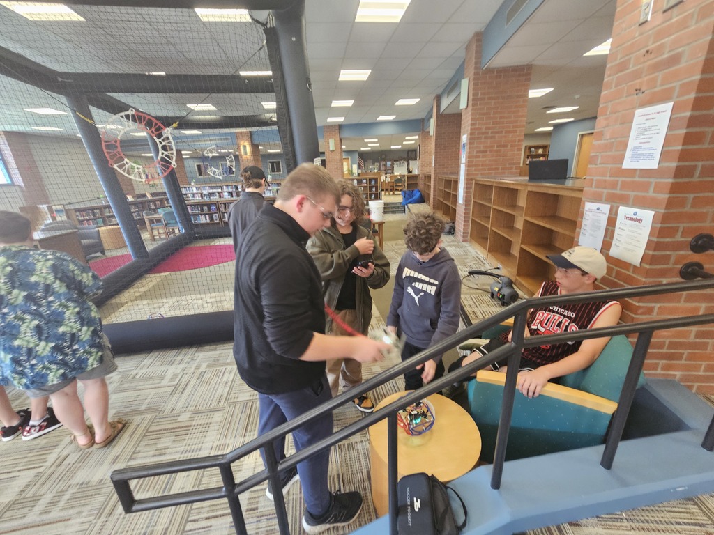 Students teaching each other how to fly drones