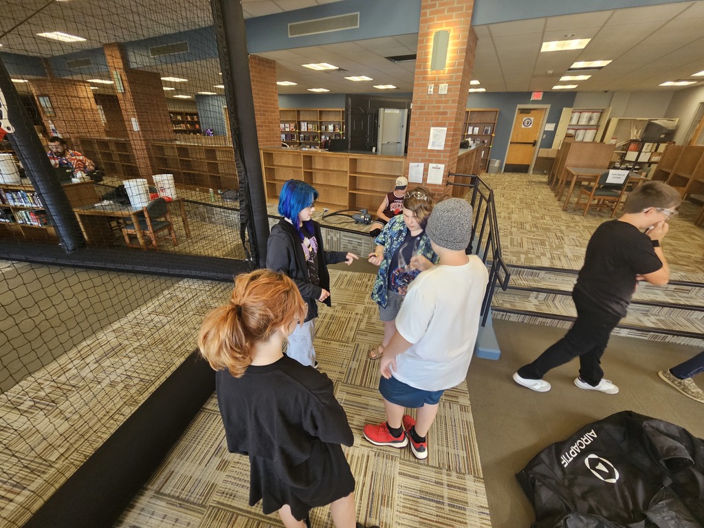 Students teaching each other how to fly drones