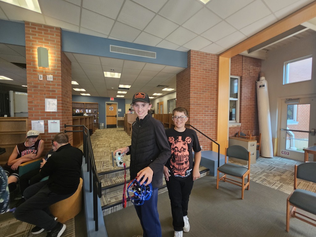 Students teaching each other how to fly drones