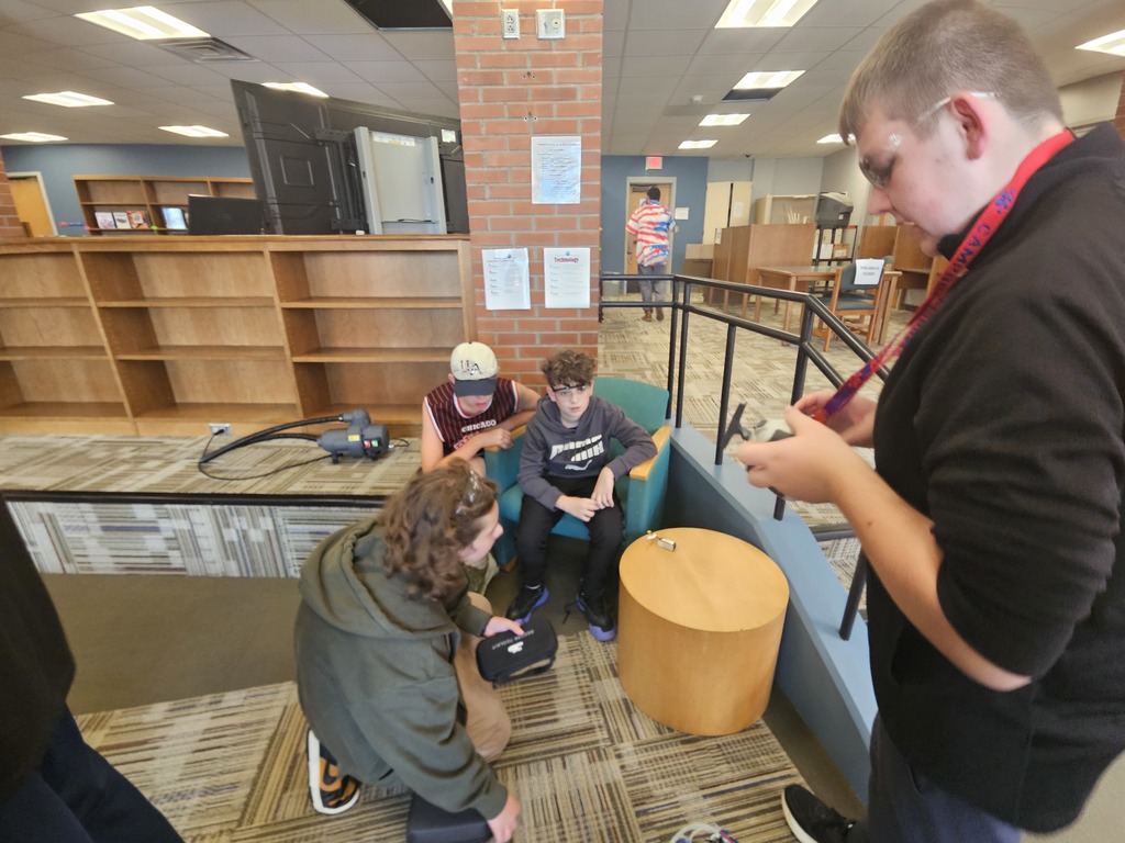 Students teaching each other how to fly drones