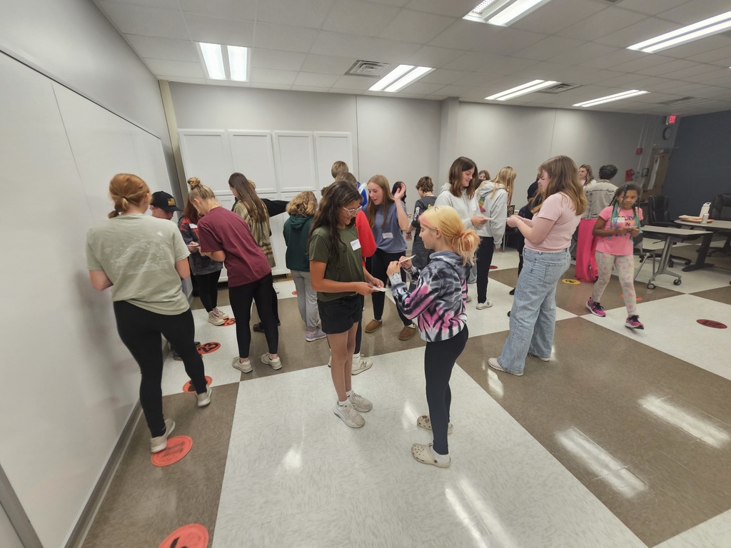 Students meeting in groups playing a game together