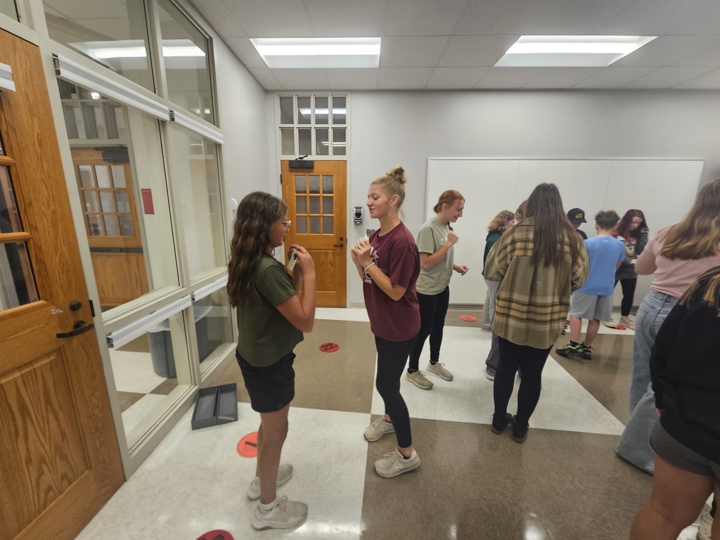 Two students interacting with each other in game standing up