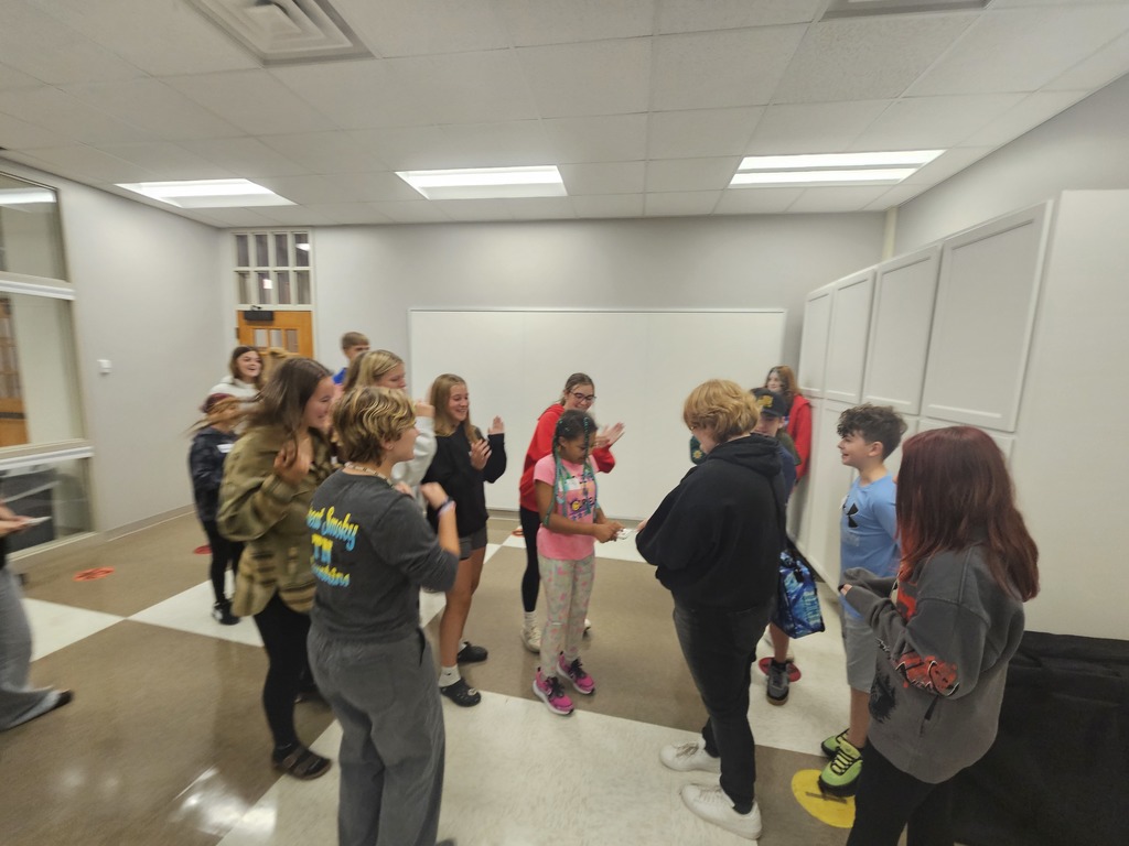 Students in a circle cheering on a peer
