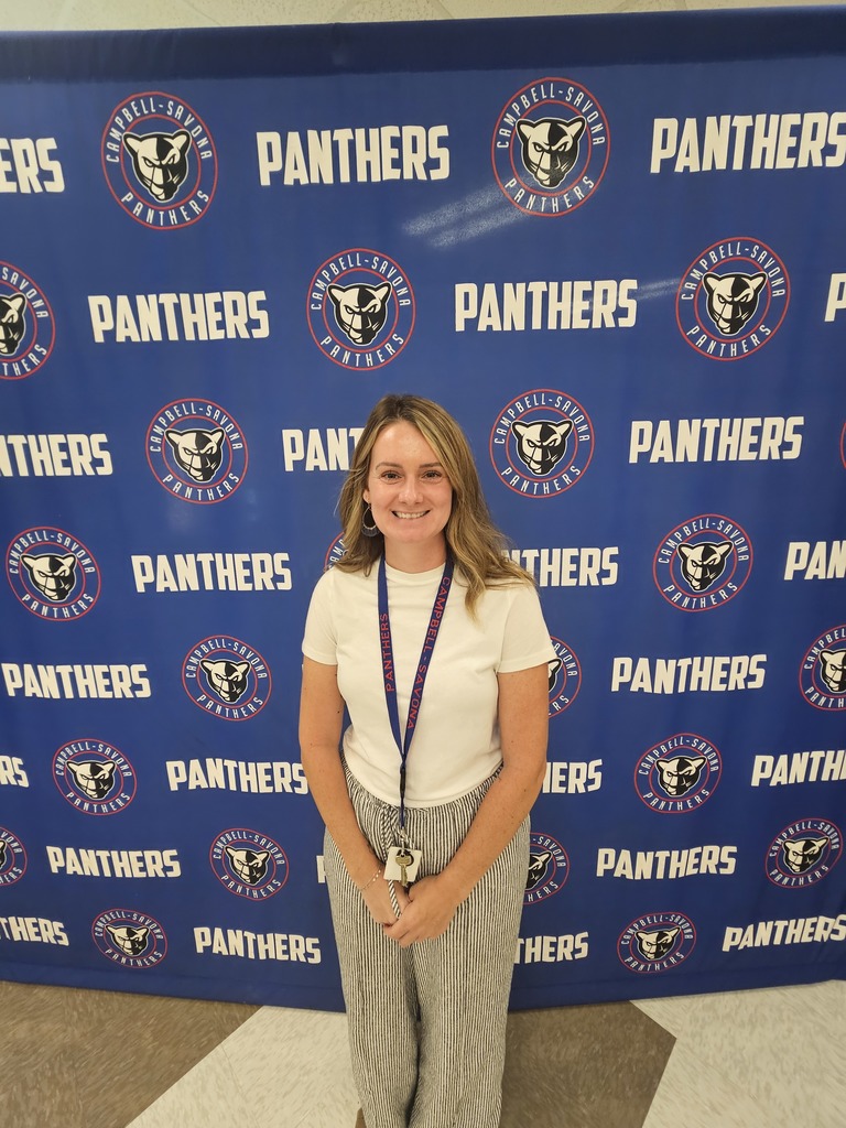 Picture of school social worker posing in front of Panther Banner