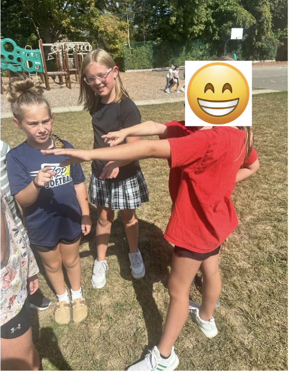 Three students holding butterfly together