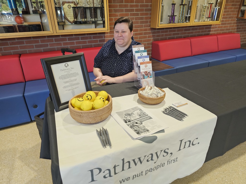 Pathways info table at open hose with worker and information laid out