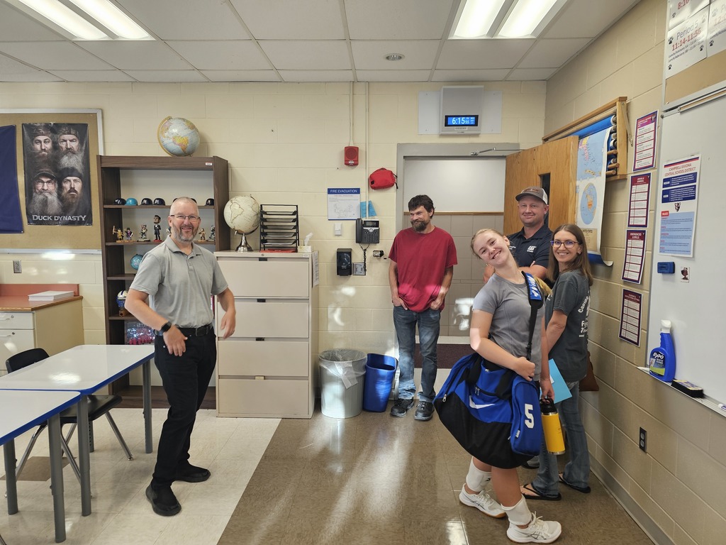 Students teacher and parents at open house smiling