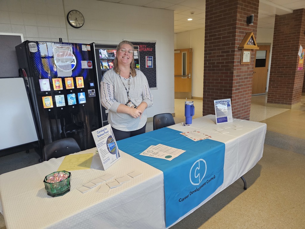 career development information table with worker at open house