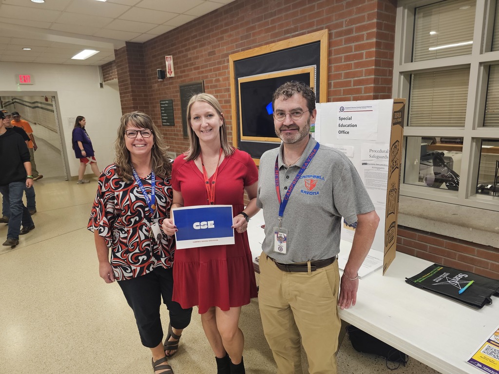 Special Education faculty smiling at information table at open house
