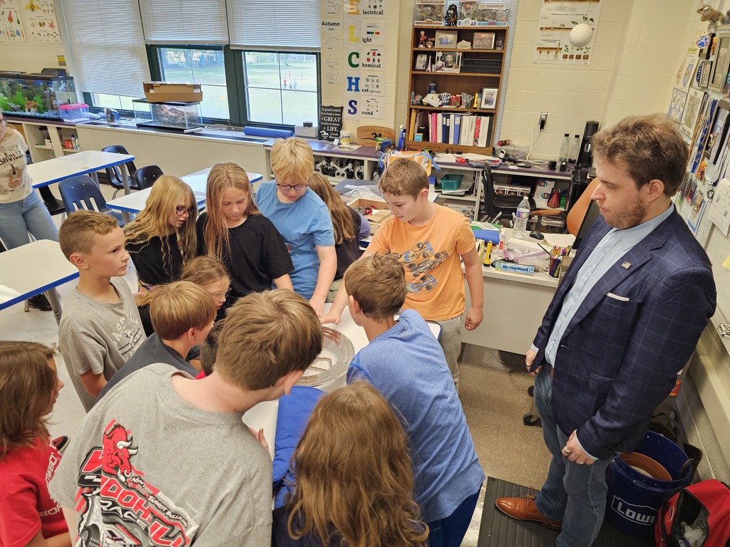 Students standing around a superconductor experiment with Dr. Vogt