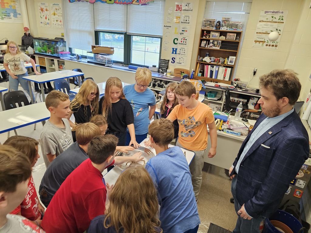 Students standing around a superconductor experiment with Dr. Vogt