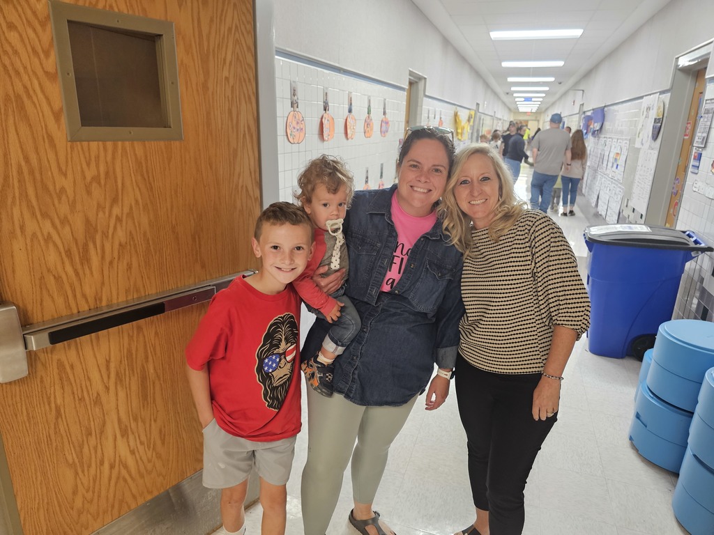 Family posing with teacher all smiling