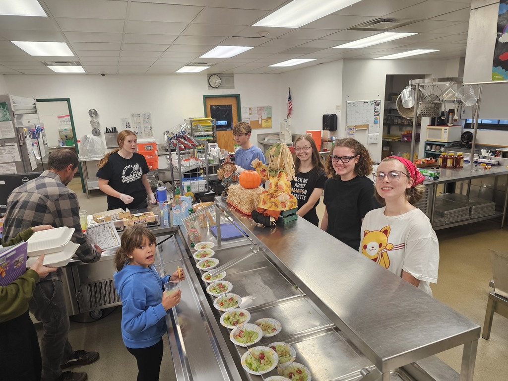 HS student workers serving spaghetti during open house in cafeteria
