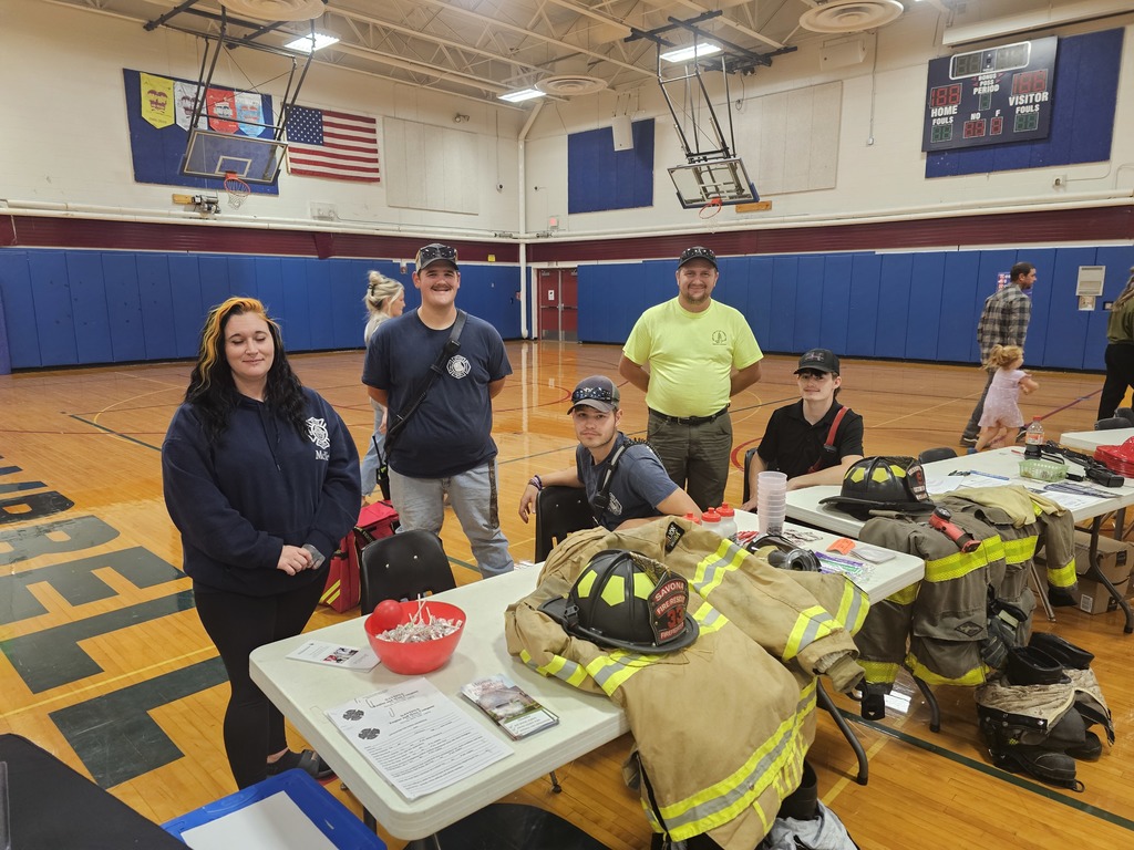 Savona fire department posing for picture during open house at informational table.
