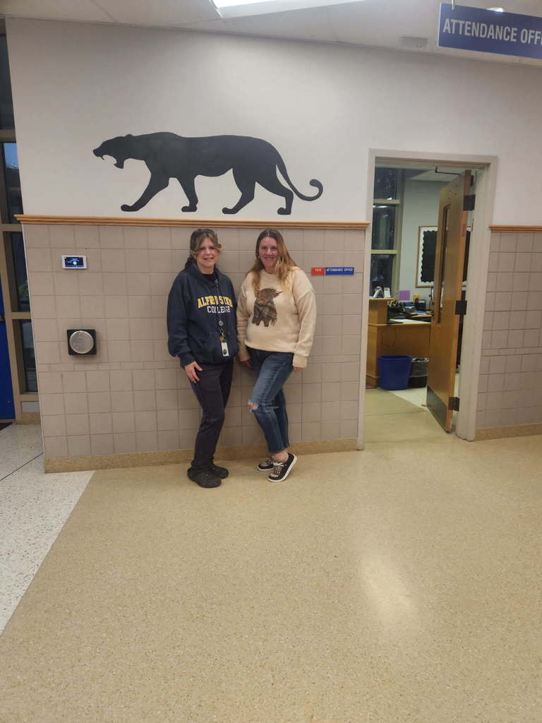 Two educators dressed as students in sweatshirts